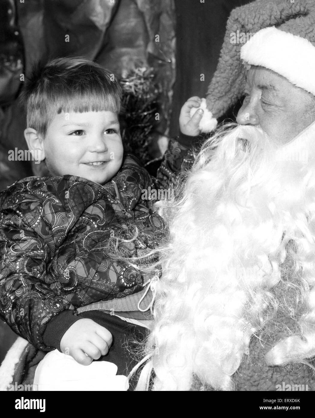 Father Christmas (aka Tom Mathieson) with two year old Scott McLaughlin in a city store's Grotto, 22nd November 1977. Stock Photo