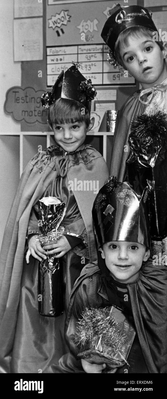 Peeping around the Bethlehem stable door, The Three Wise Men bearing gifts of Gold, Frankincense and Myrrh for the baby Jesus. The 5 year old Pinnell triplets from Pentwyn, Cardiff, taking part in their St Bernadette R C School Nativity play. They are Anthony (top), Richard (left) and Joseph (bottom). 15th November 1989. Stock Photo
