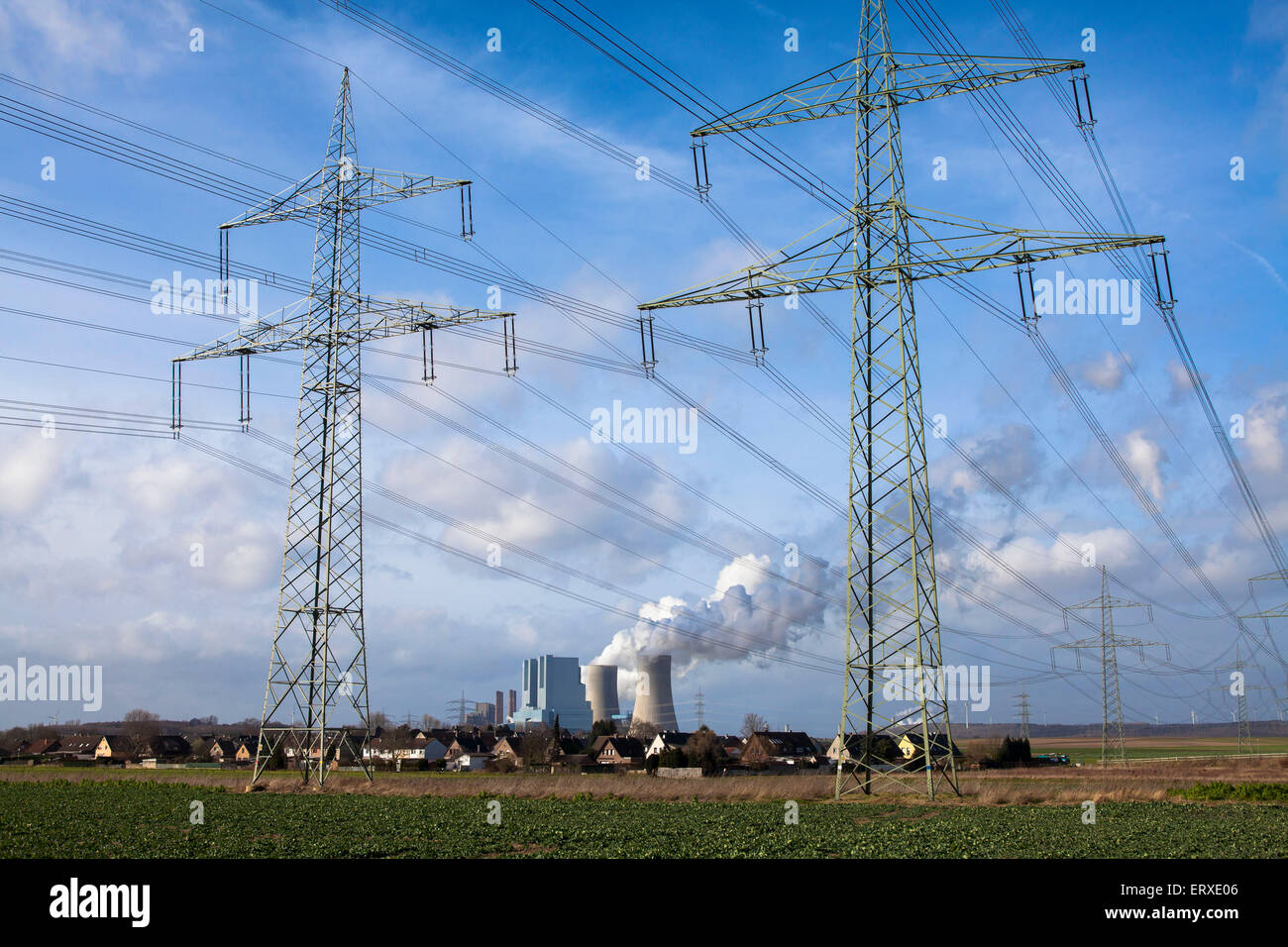 the lignite-fired power plant Neurath in Grevenbroich, Germany, in the foreground houses in Rommerskirchen-Vanikum. Stock Photo