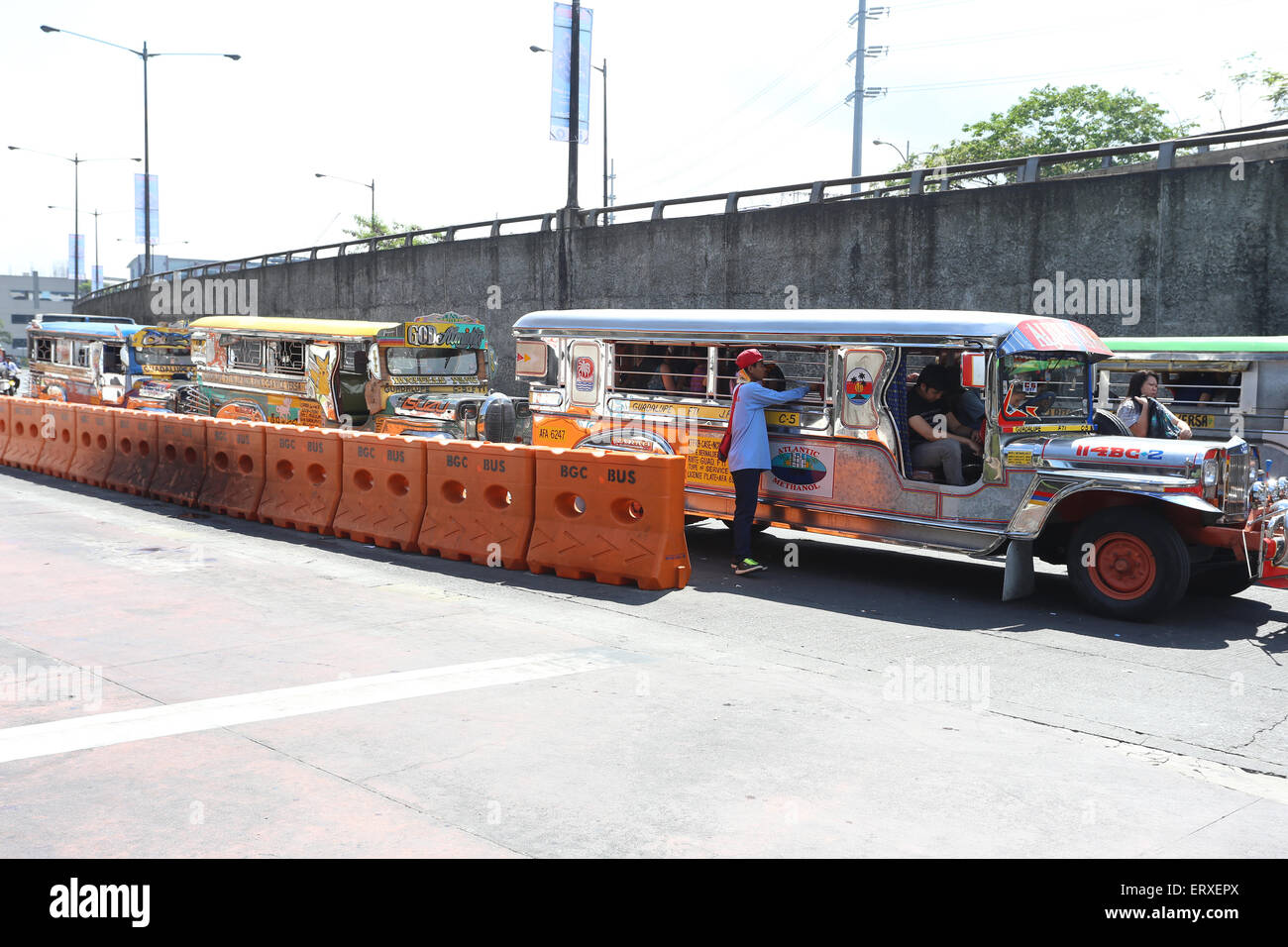 colorful jeepneys known for their crowded seating and kitsch decorations, which have become a ubiquitous symbol Stock Photo
