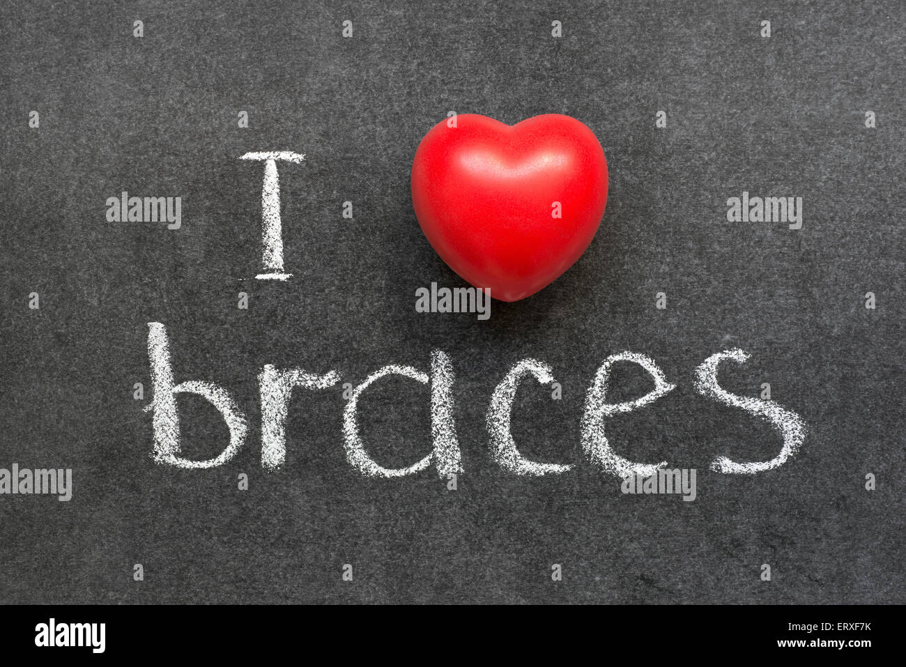 I love braces phrase handwritten on chalkboard with red heart symbol ...