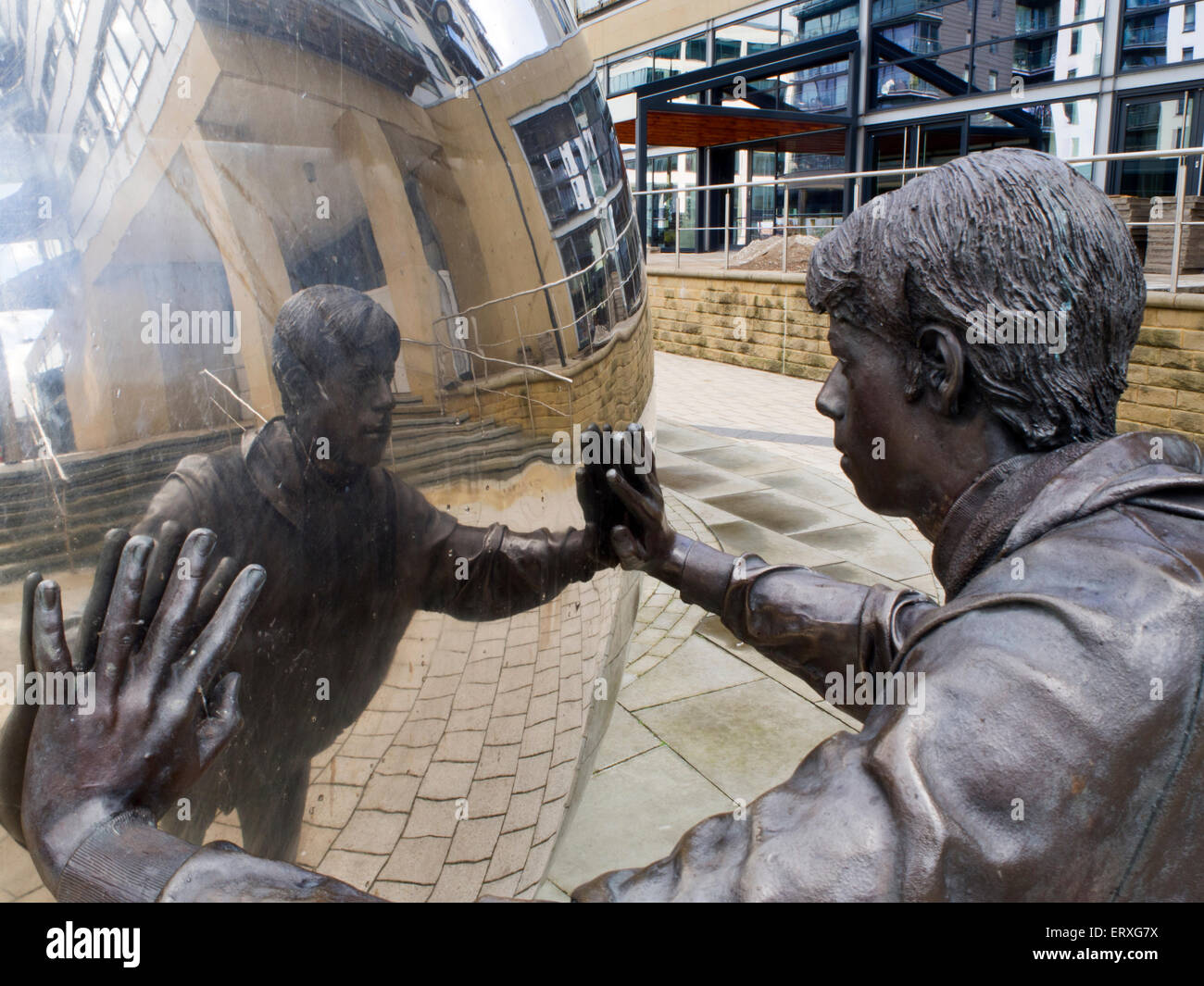 Reflective Metal Ball and Bronze Statue Sculpture at Clarence Dock Leeds West Yorkshire England Stock Photo