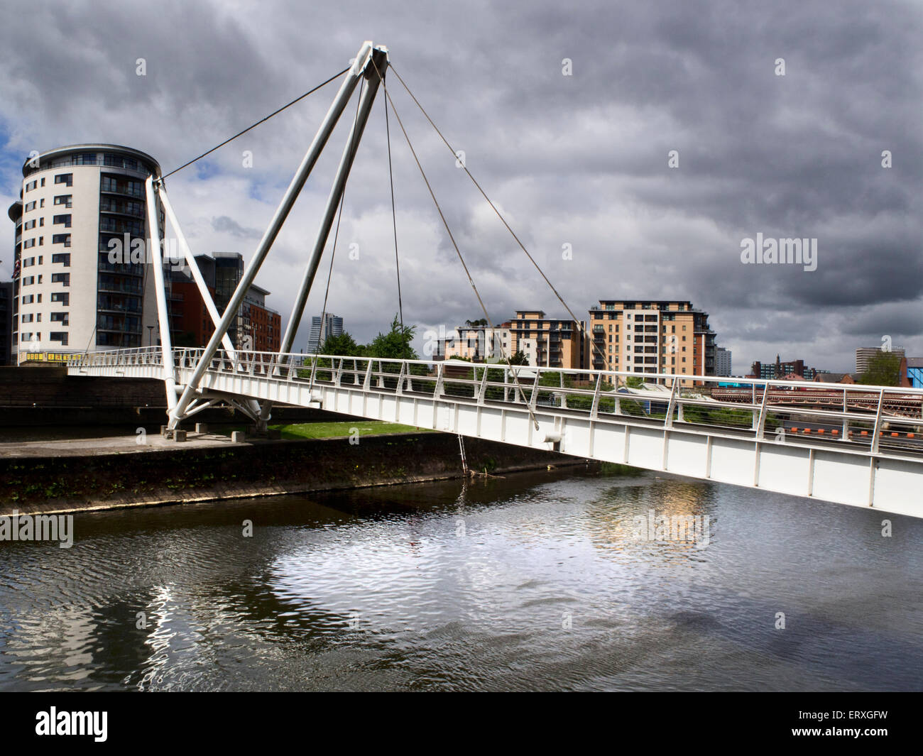 Dark Clouds over Knights Way Bridge over the River Aire at Royal Armouries Leeds West Yorkshire England Stock Photo