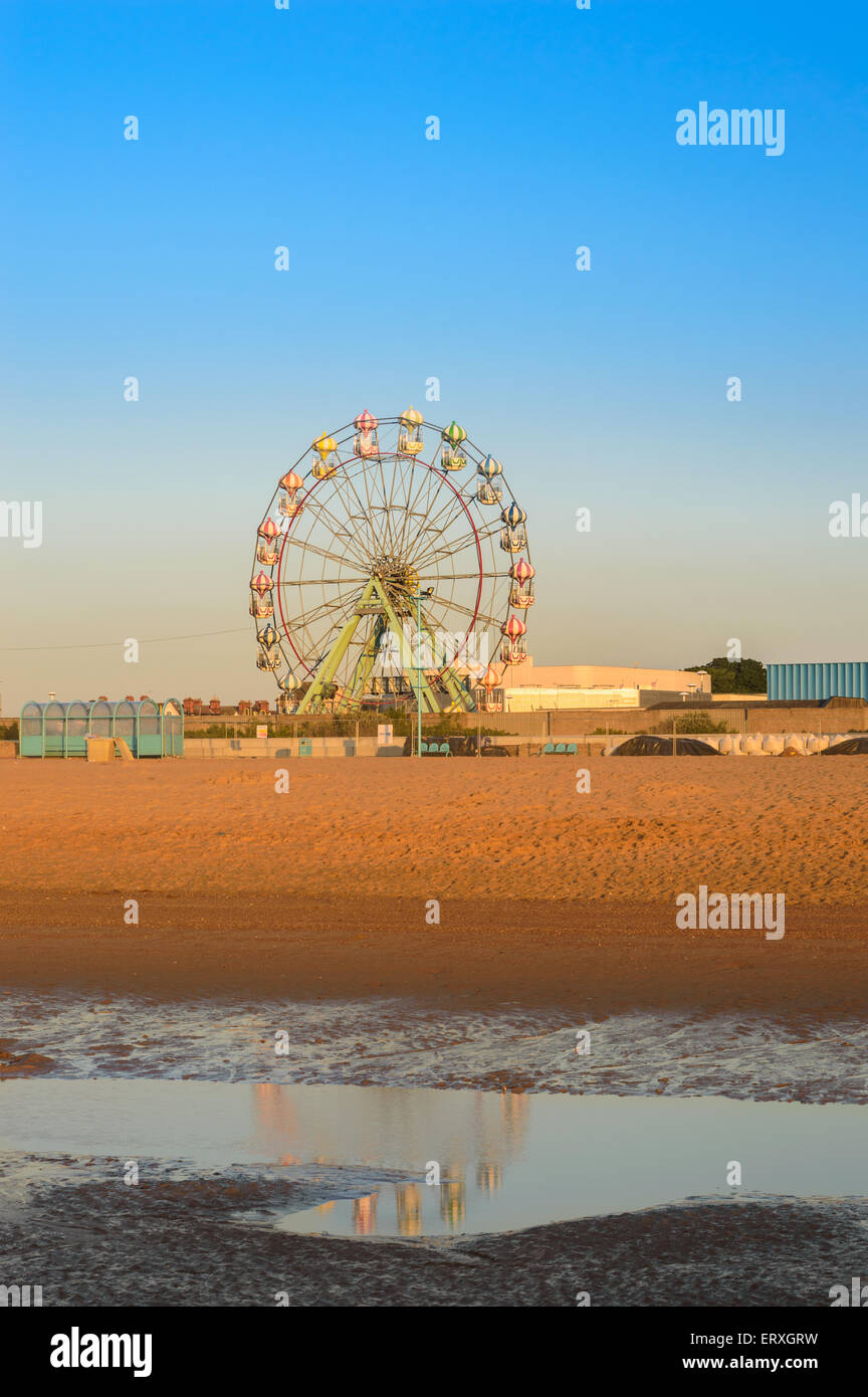 Skegness beach, and the big wheel reflected in a rock pool, early morning, in June. In Skegness, Lincolnshire, England Stock Photo