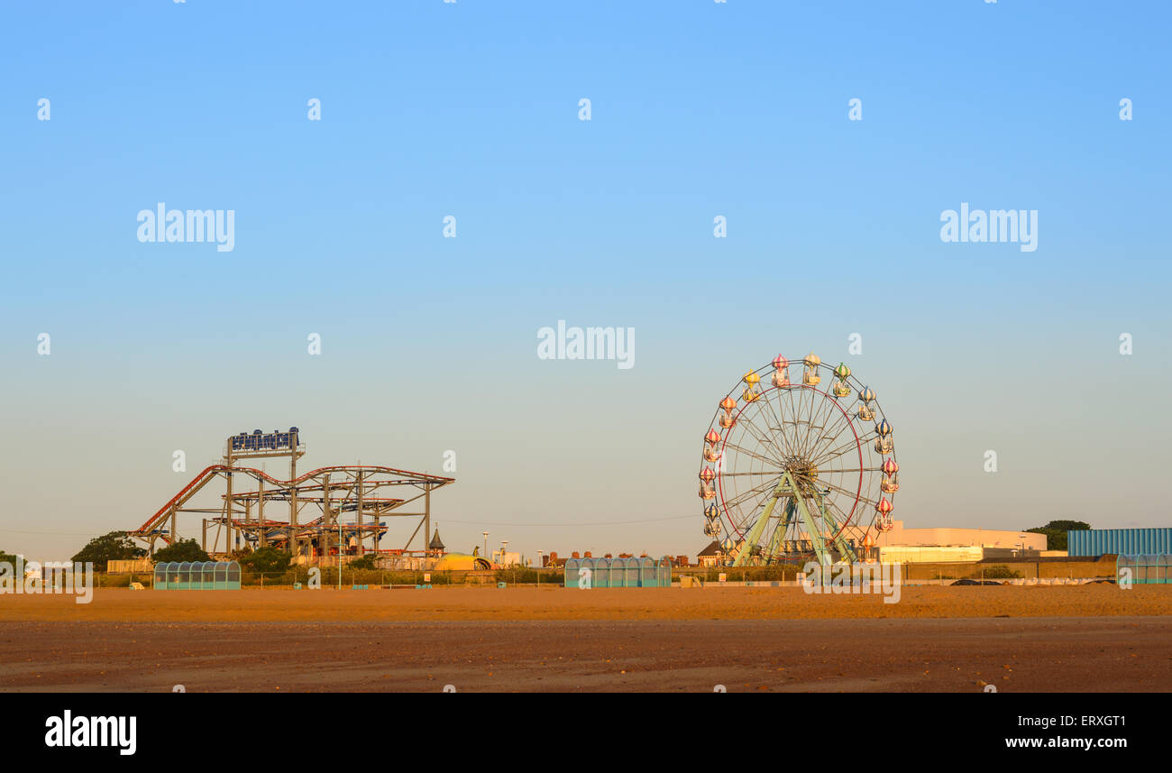 Skegness beach, the big wheel and the fair ground, early morning, in June. In Skegness, Lincolnshire, England Stock Photo