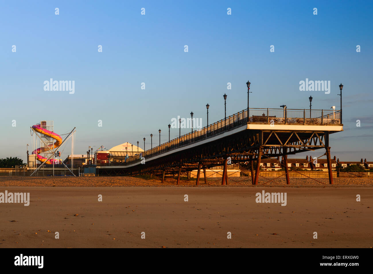 Skegness pier, the beach, and the fair ground, early morning, in June. In Skegness, Lincolnshire, England Stock Photo