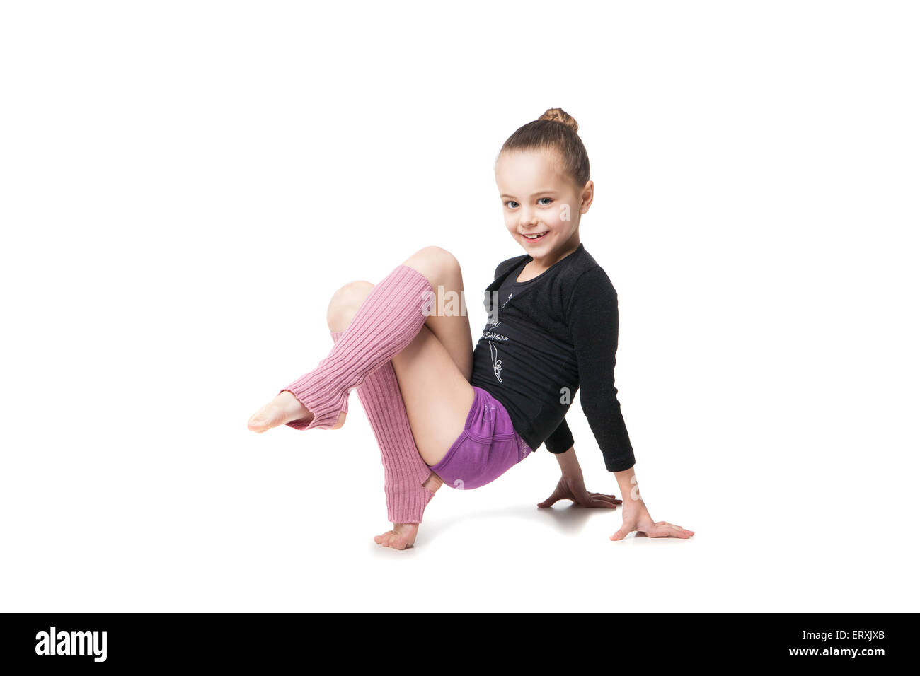 Young little girls gymnastics Portrait of a pretty little girl doing gymnastics over white background  Stock Photo - Alamy