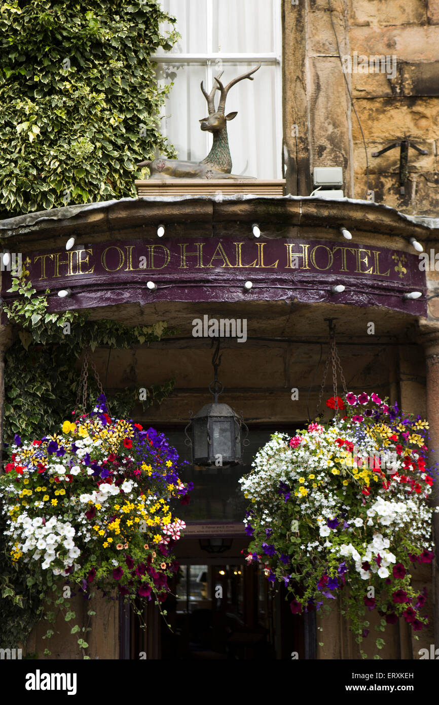 UK, England, Derbyshire, Buxton, The Square, Old Hall Hotel, stag above entrance and hanging baskets Stock Photo