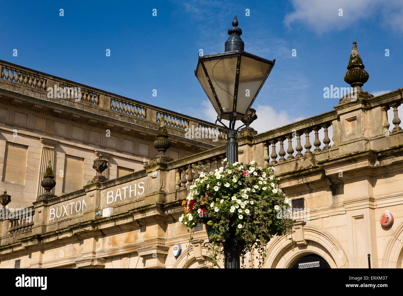 UK, England, Derbyshire, Buxton, The Crescent, floral basket on lamp post outside former baths building Stock Photo