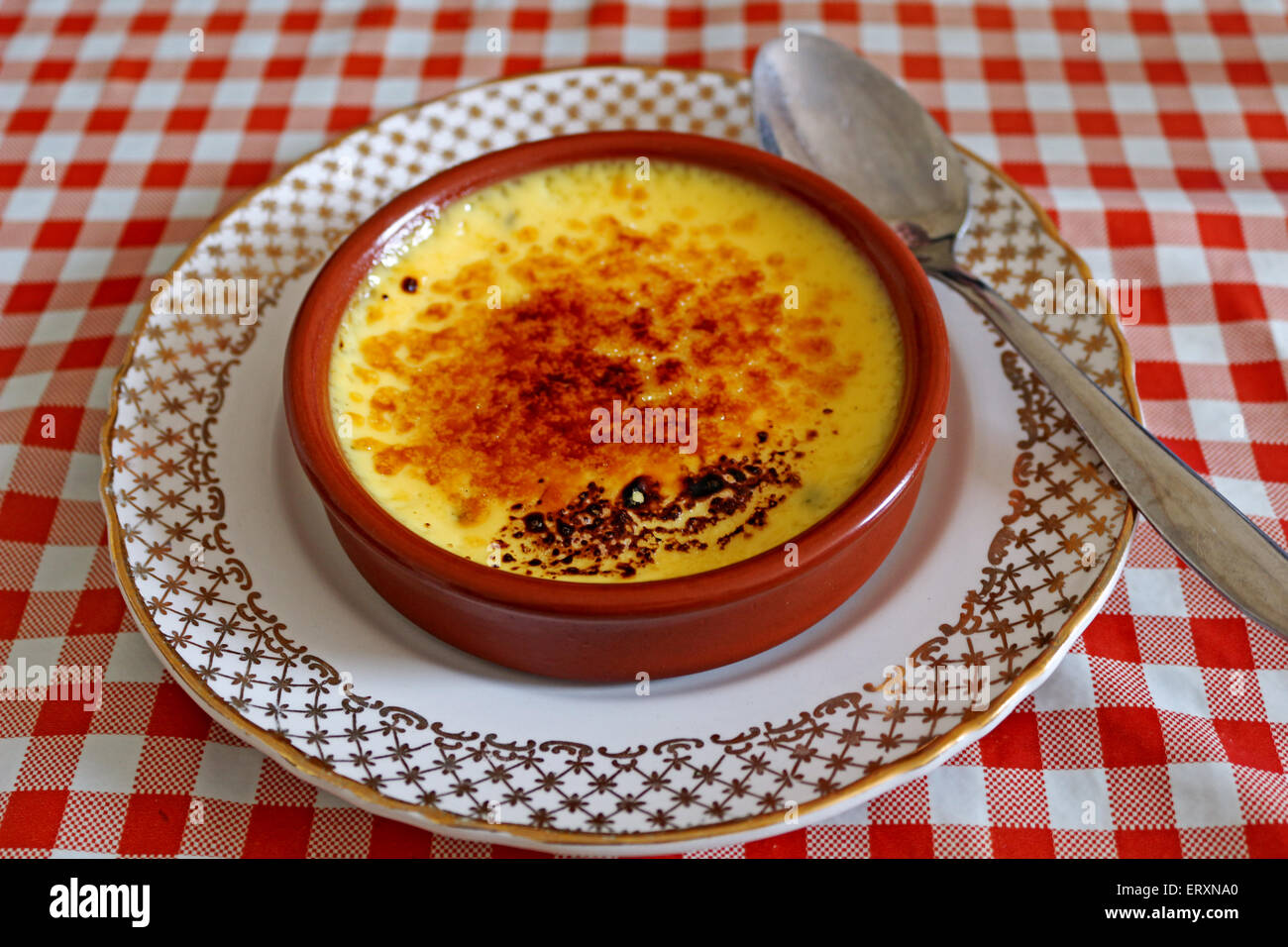 creme brulee on gingham table Stock Photo