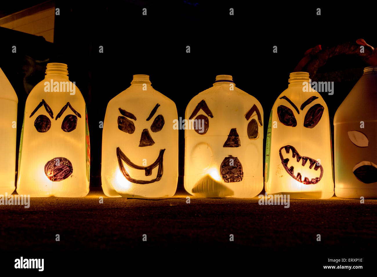 Halloween luminaries made from recycled plastic jugs and candles Stock Photo