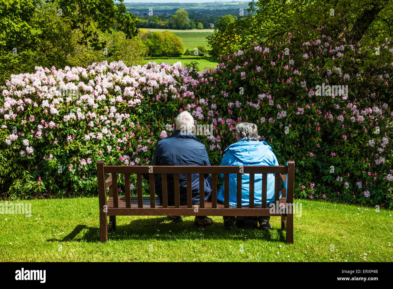 An elderly couple enjoy the view from the mausoleum of the Bowood Estate over the landscape of Wiltshire. Stock Photo