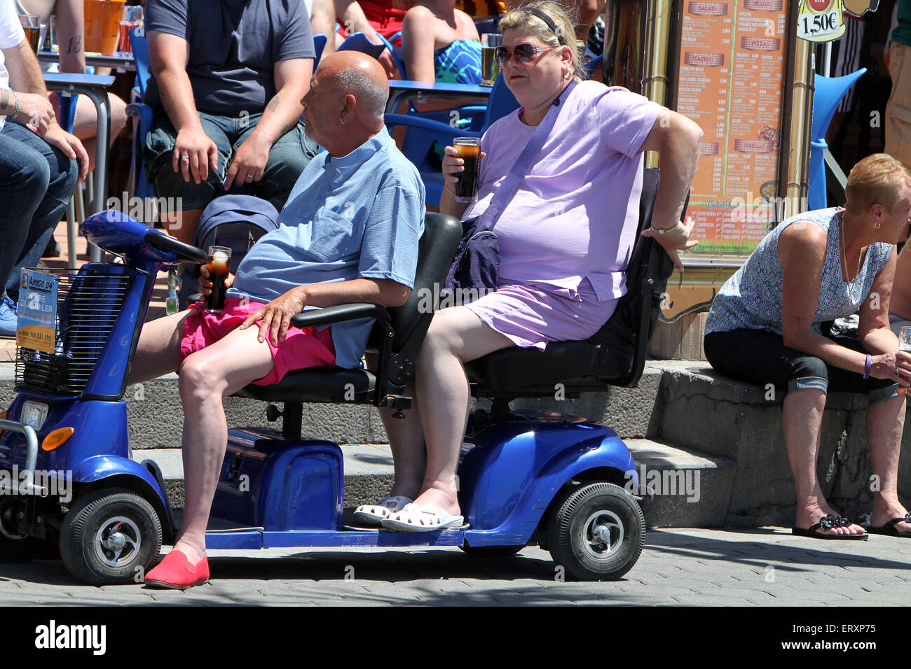 Couple enjoying a Drink on mobility scooter (credit image © Jack Ludlam