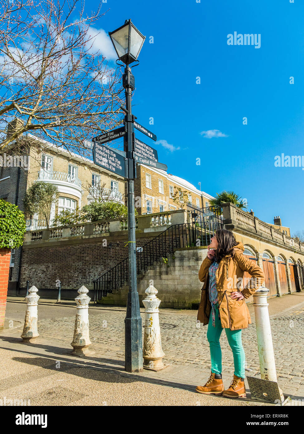 Woman Looking at a Sign Post and Thinking Stock Photo