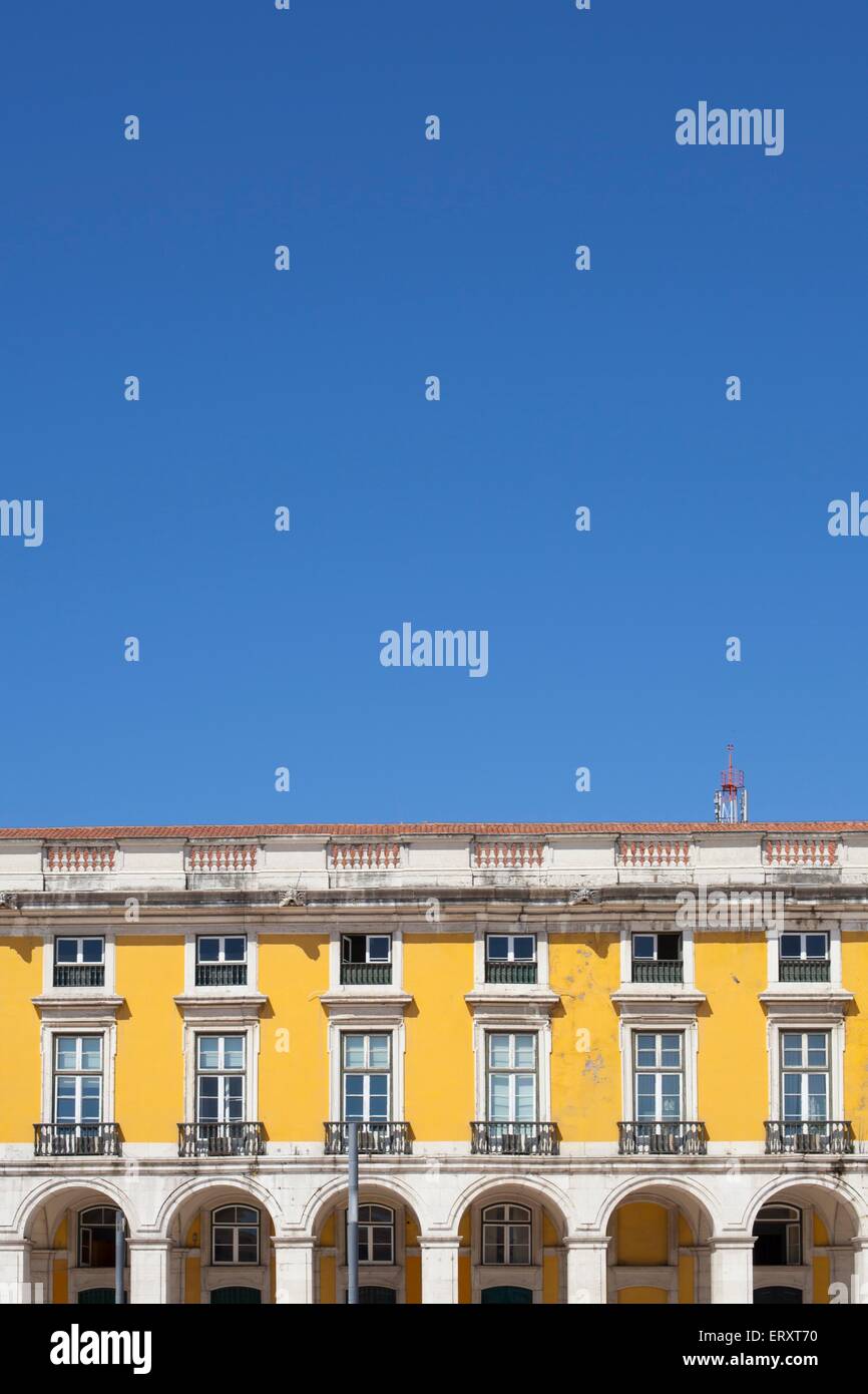Colourful buildings in Praca de Comercio of Lisbon against a bright blue sky in summer Stock Photo