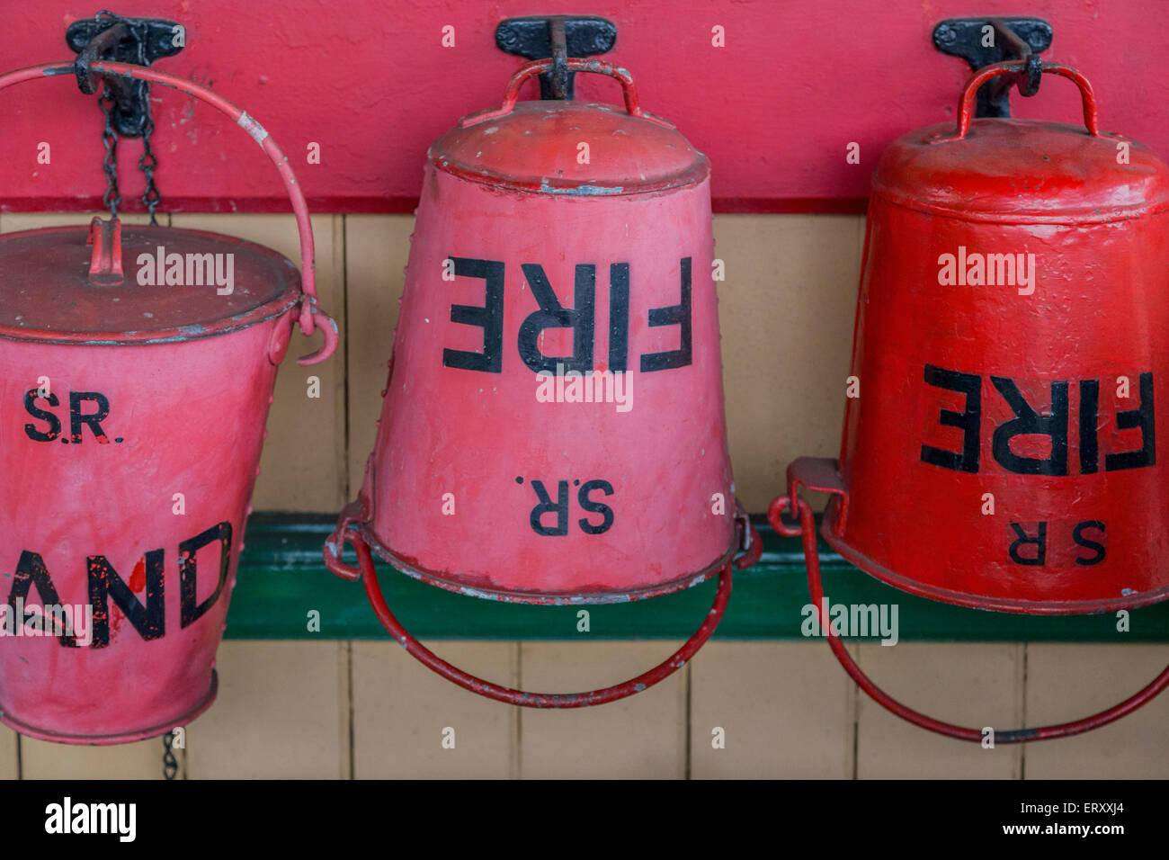 Red fire buckets at Horsted Keynes Railway Station on the Bluebell Railway Heritage Line, West Sussex, England, United Kingdom. Stock Photo