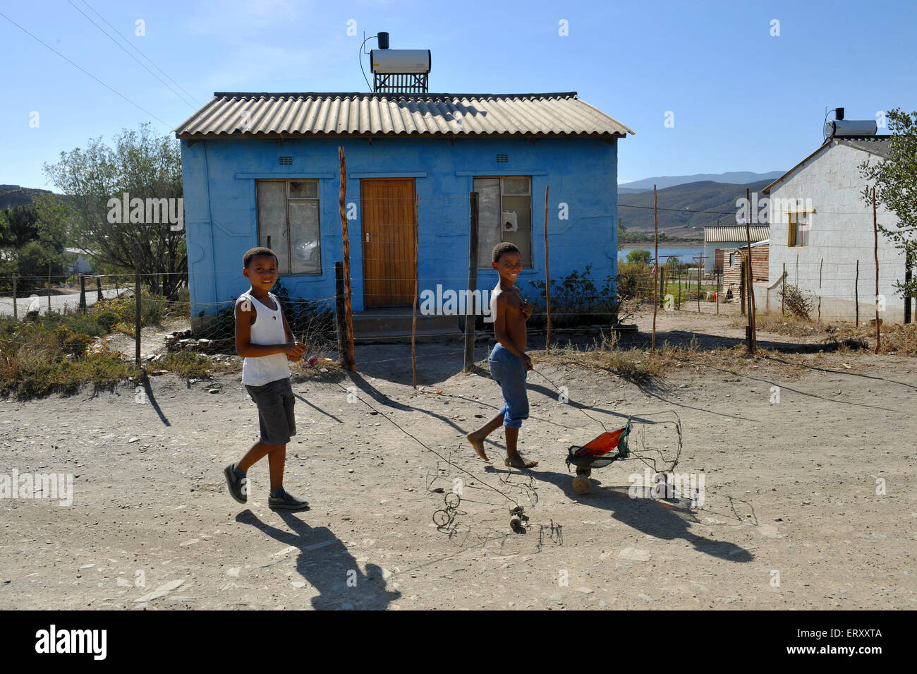 Boys play with homemade toys in the township of Barrydale, Western Cape, South Africa Stock Photo