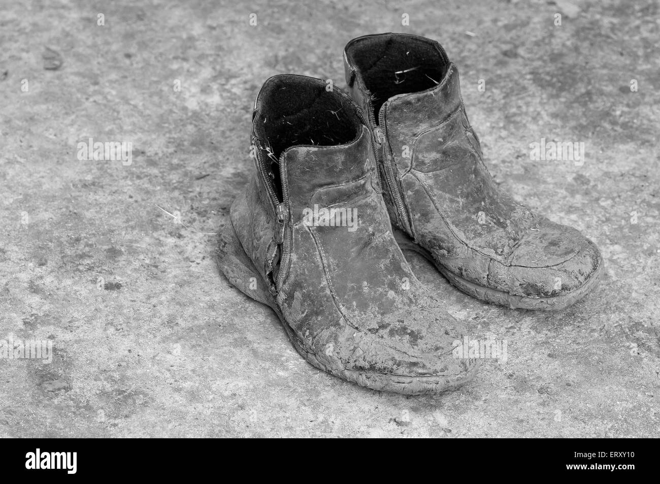 Pair of very dirty boots black and white picture Stock Photo Alamy