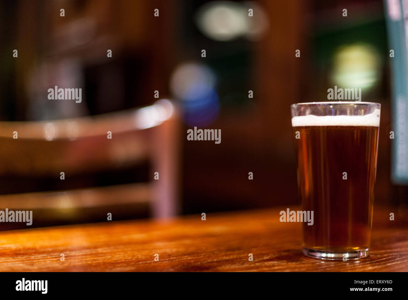 A pint of beer on a pub table Stock Photo