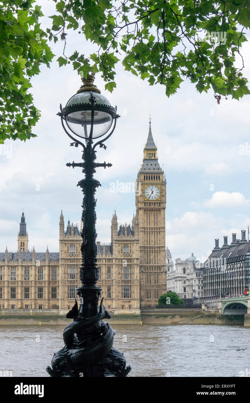 A dolphin lamp standard on the Albert Embankment across the River Thames from Big Ben and the Houses of Parliament. Stock Photo