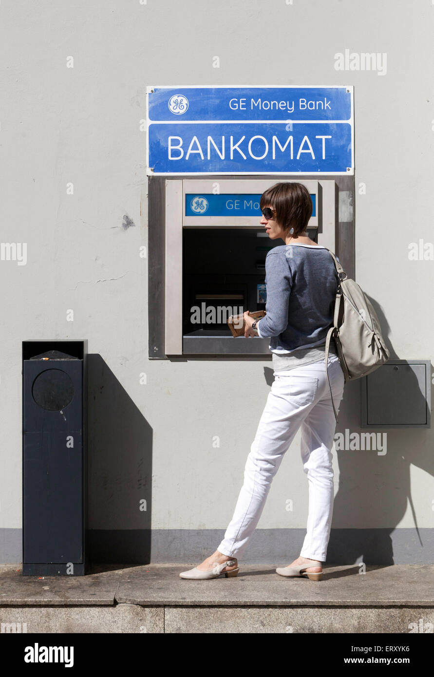 GE Money Bank woman ATM money withdraw, Czech Republic Stock Photo