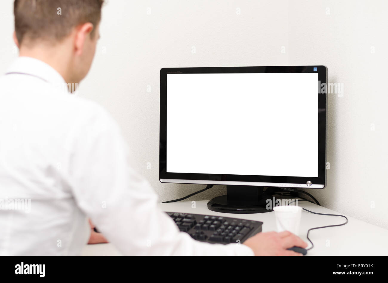 Adult looking at computer screen behind hires stock photography and