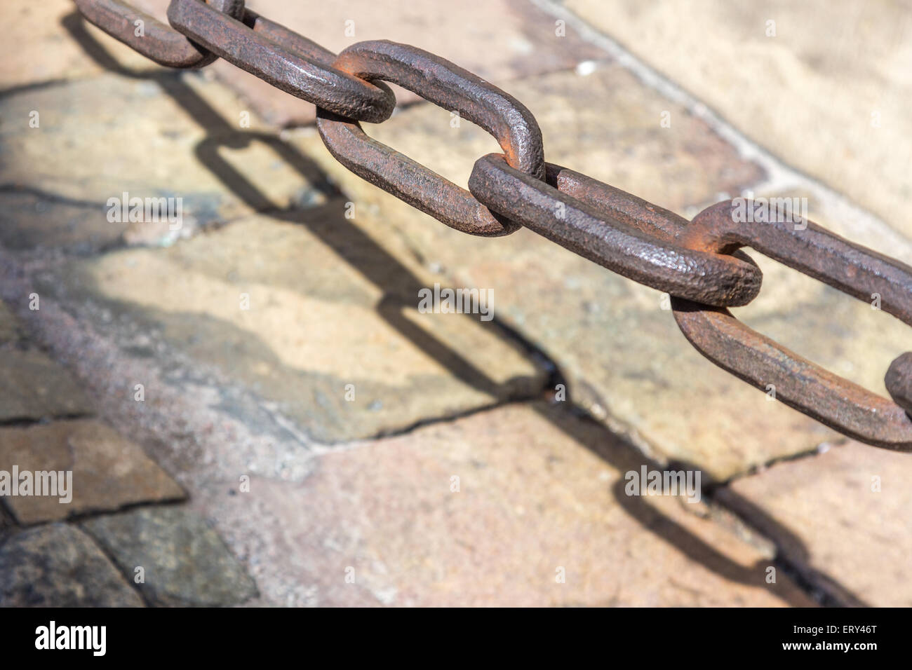 A Heavy Brass Chain Link and Shadow Stock Photo