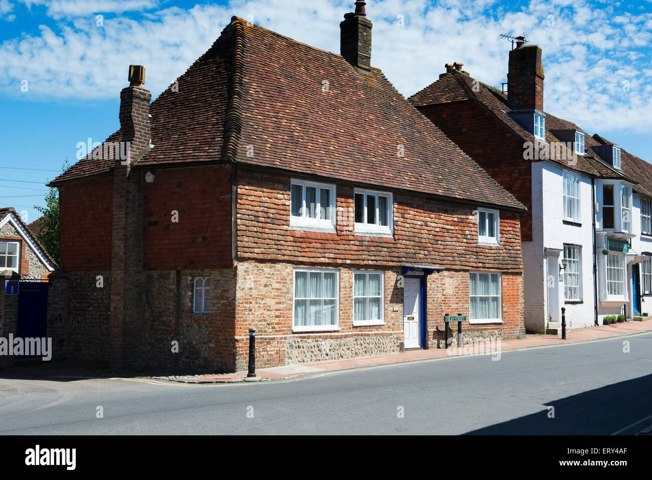 A brick, tile and flint cottage (the 'Manor House') on Alfriston village High Street Stock Photo