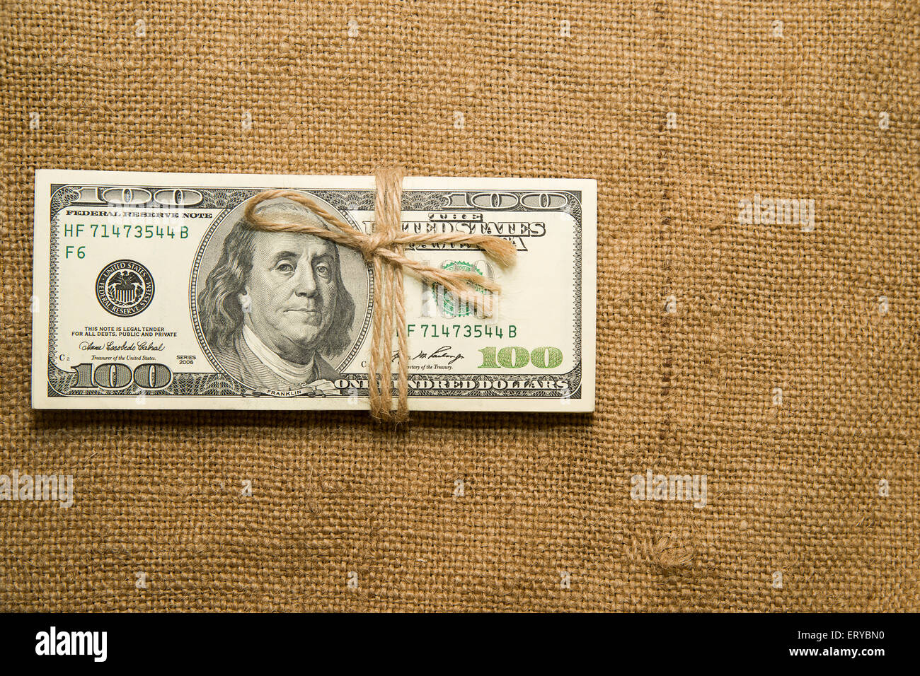 One pack of dollars tied up with rope in the old cloth Stock Photo
