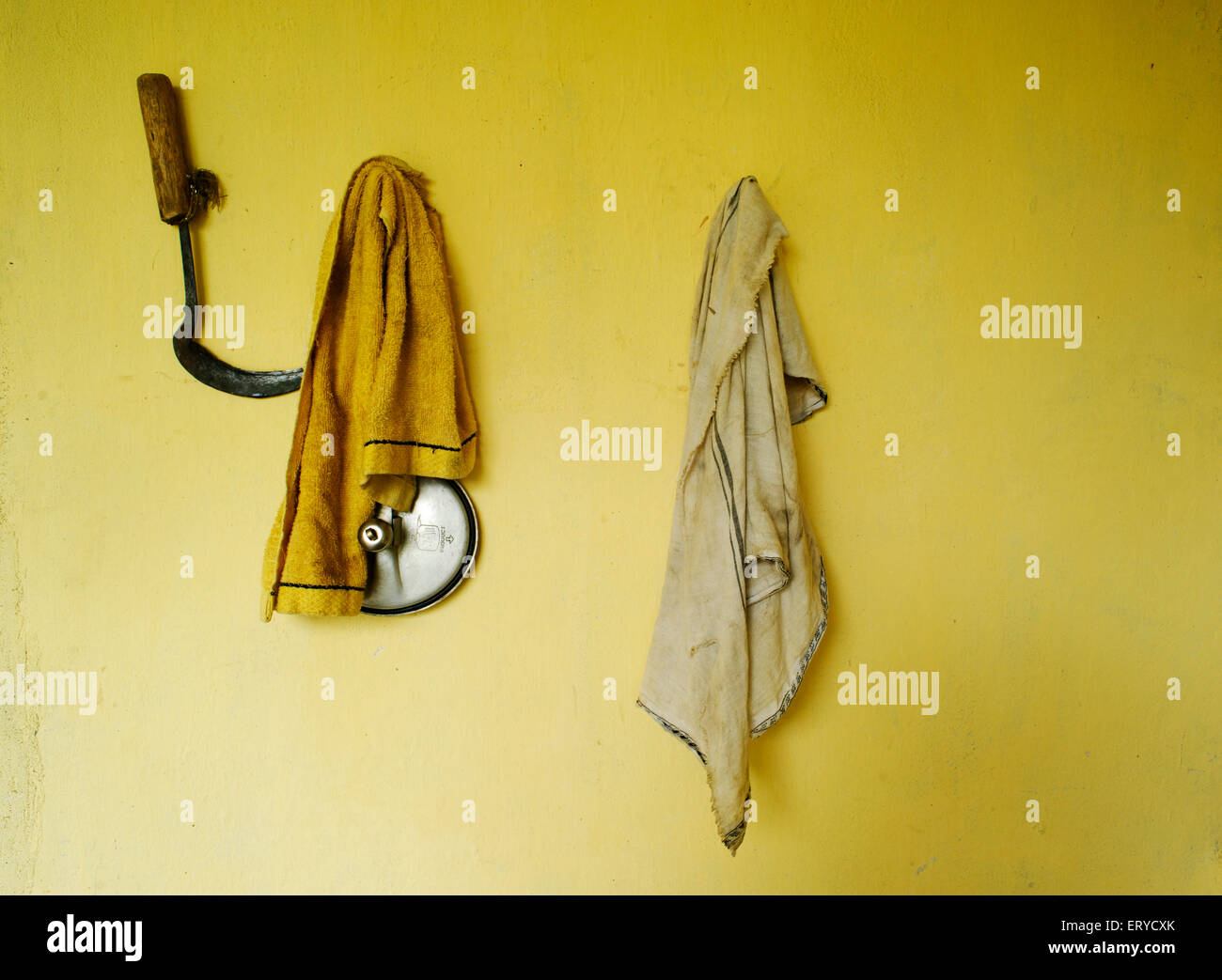 Sickle and clothes hanging on peg , Lumbini , Nepal , Asia Stock Photo