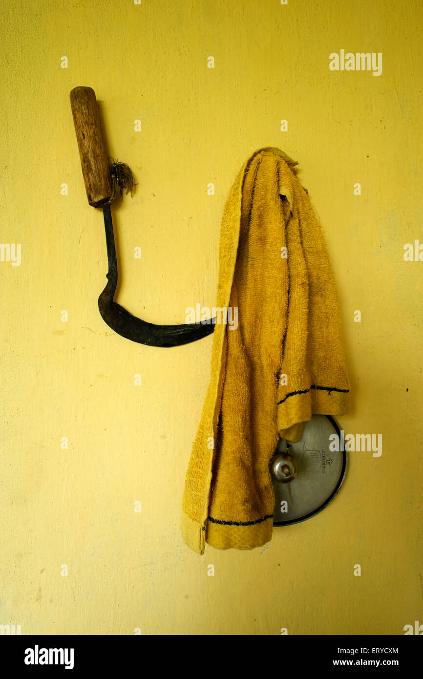 Sickle and clothes hanging on peg , Lumbini , Nepal , Asia Stock Photo