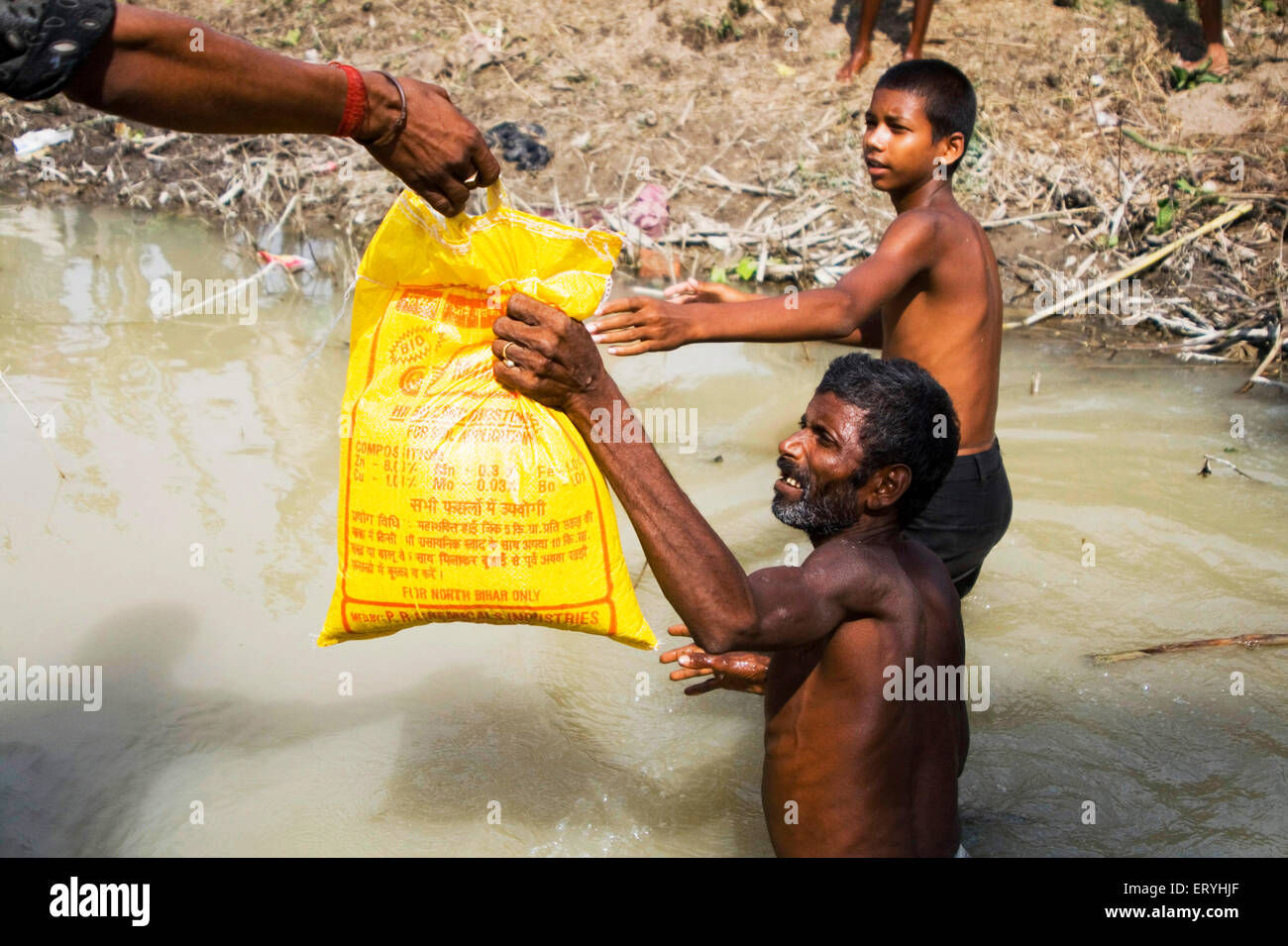 Supply of food package ; Kosi river flood 2008 mostly suffered below poverty line people in Purniya ; Bihar Stock Photo