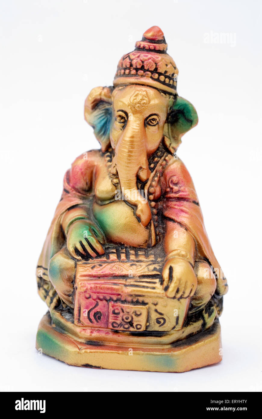 Colourful statue of lord Ganesha elephant headed god playing harmonium ; India Stock Photo