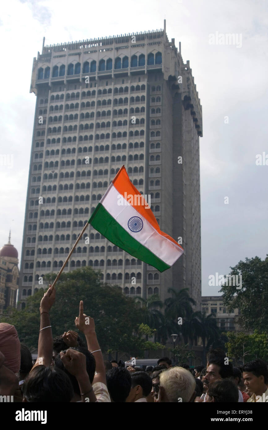 Activist holding tricolour Indian flag during a peace rally at hotel Taj mahal ; Colaba ; Bombay Mumbai ; Maharashtra ; India Stock Photo