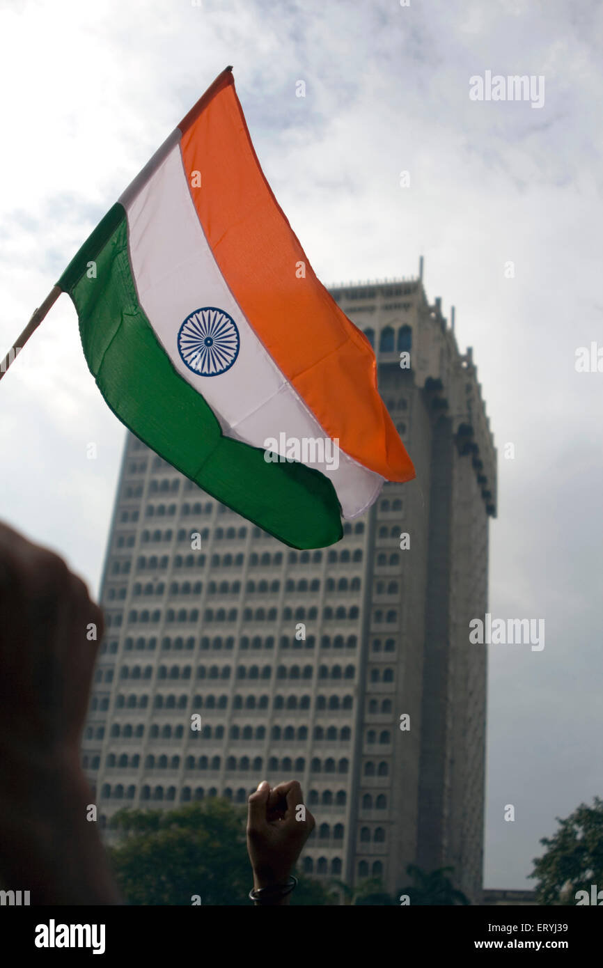 Activist holding tricolour Indian flag during a peace rally at hotel Taj mahal ; Colaba ; Bombay Mumbai ; Maharashtra ; India Stock Photo