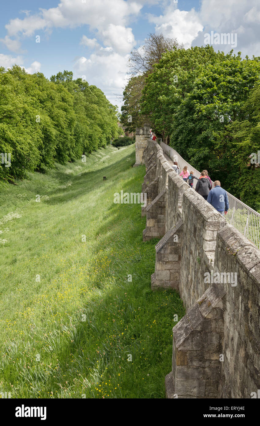 People walking around the historic city walls at York, Yorkshire, England Stock Photo
