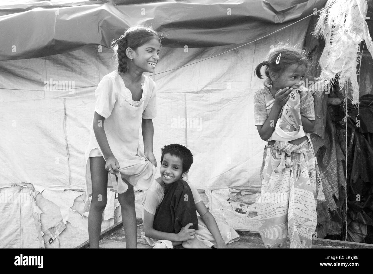 Children laughing ; Malvani slum ; Malad ; Bombay Mumbai ; Maharashtra ; India Stock Photo