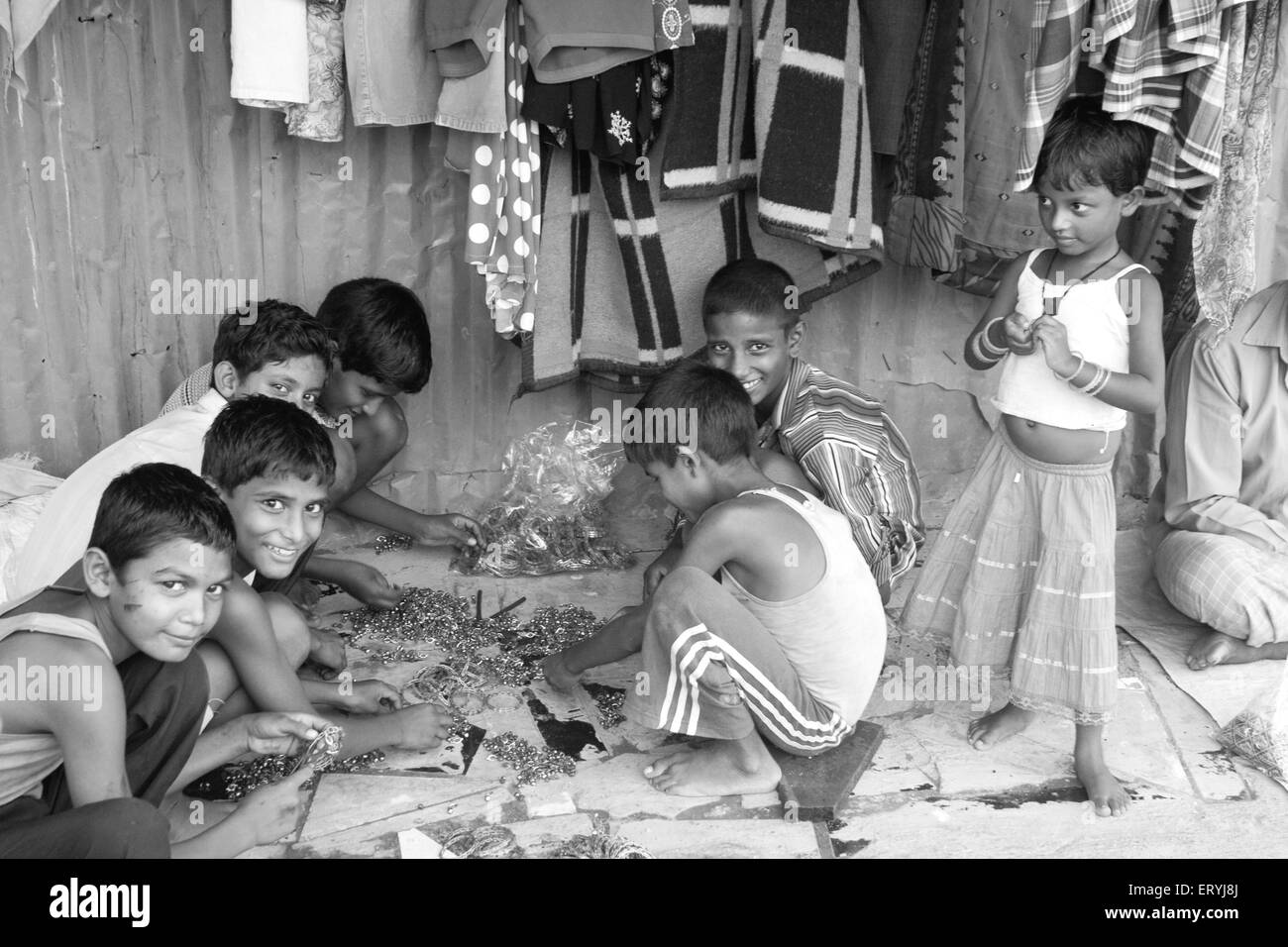 Child labor in Malvani slum ; Malad ; Bombay ; Mumbai ; Maharashtra ; India ; Asia ; Asian ; Indian Stock Photo