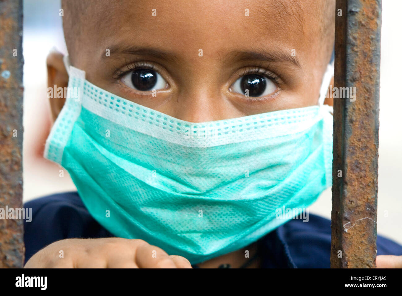 Boy wearing mask avoiding swine flu ; Bombay Mumbai ; Maharashtra ; India NO MR Stock Photo