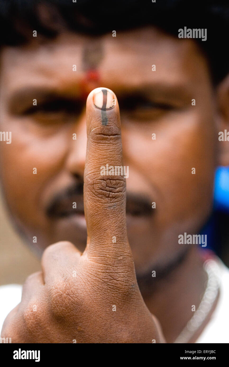 Voter showing finger with indelible ink mark after voting in election , Bombay ,  Mumbai , Maharashtra , India , Asia Stock Photo