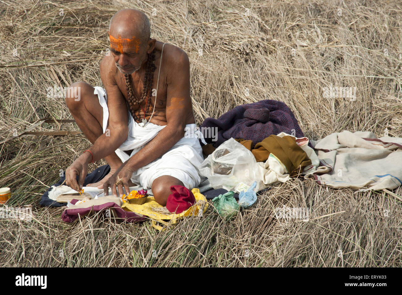 priest reading holy book in Kumbh Mela Festival at uttar pradesh India Stock Photo