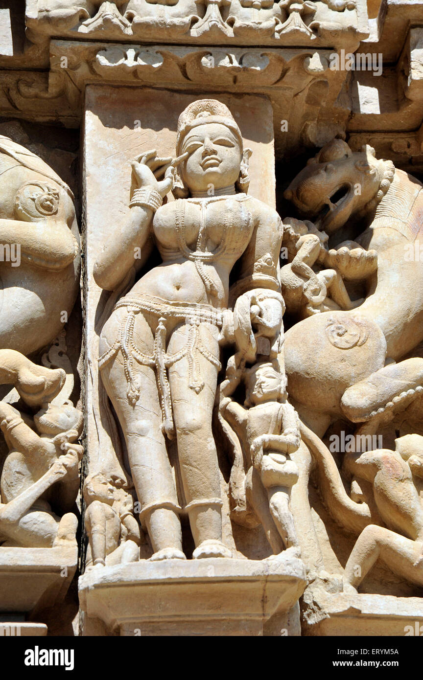A Nymph applying kajal in her eye  parsvanath temple Madhya Pradesh India Asia Stock Photo