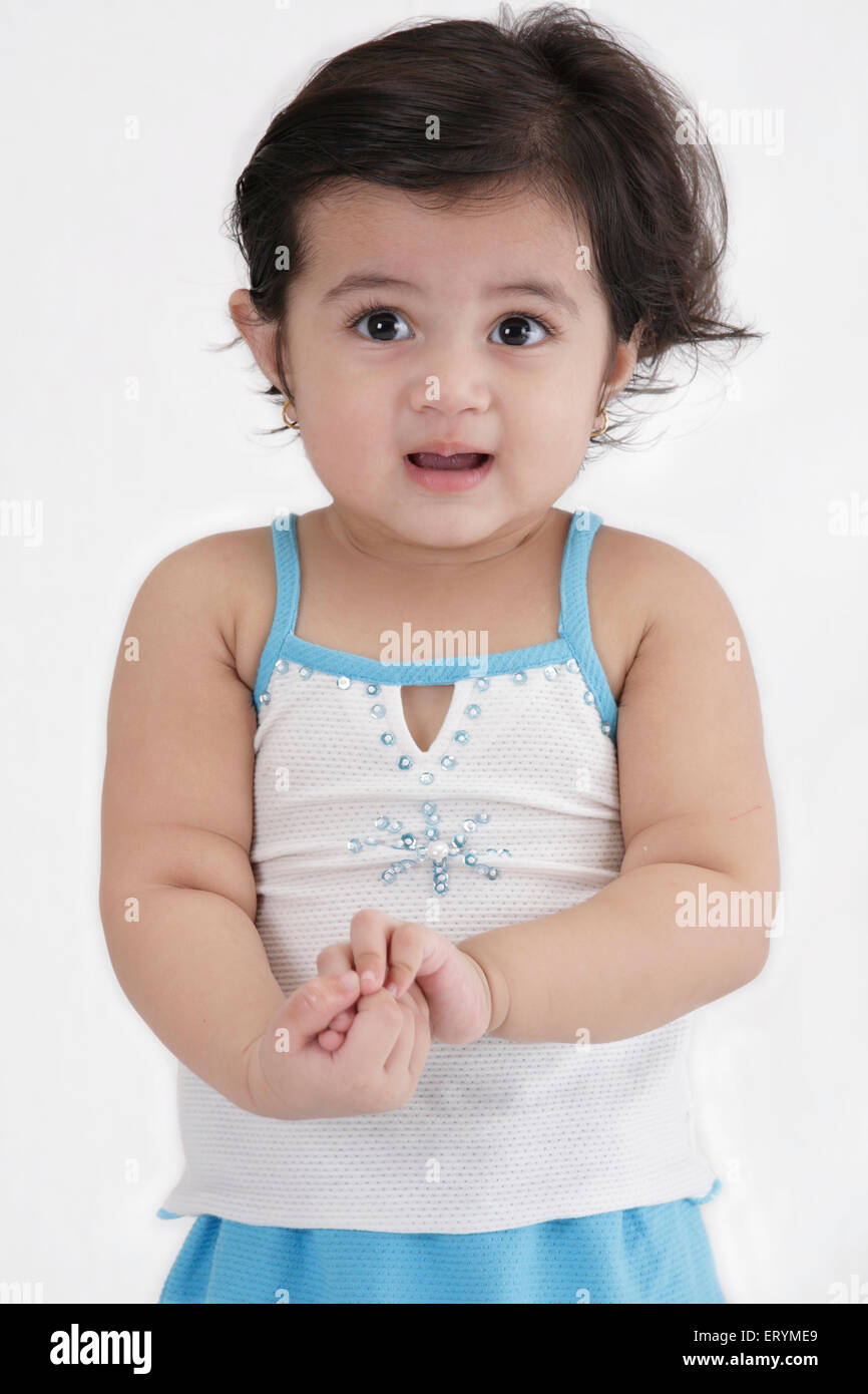 Fifteen month old baby girl standing both hands joined together MR743S