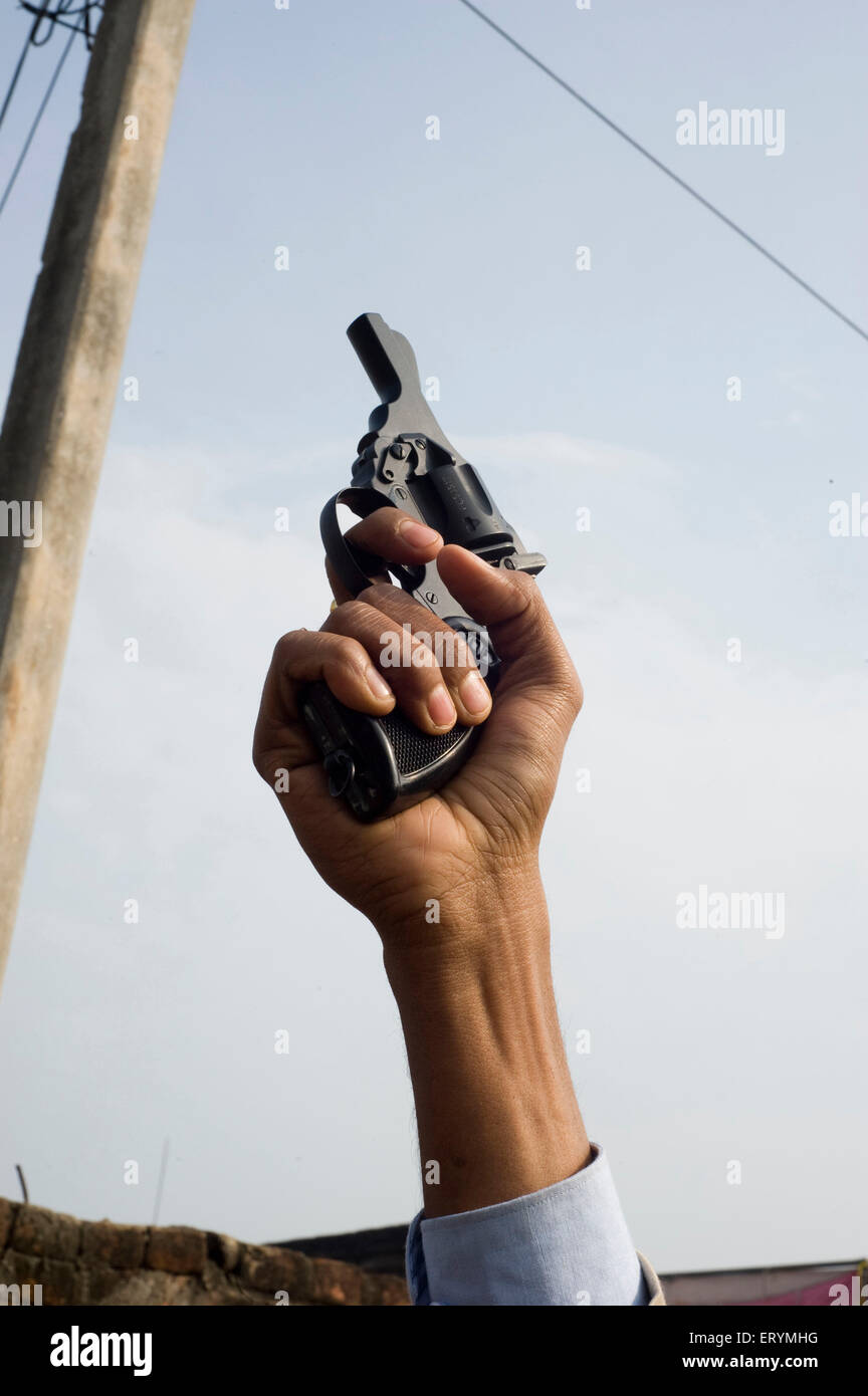 Revolver pistol in hand Stock Photo
