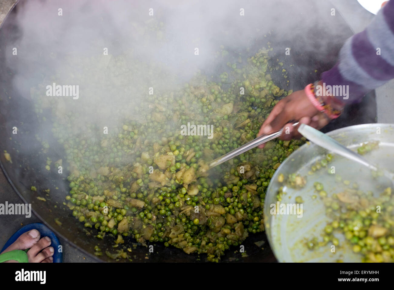 Chuda Mater frying  green peas Uttar Pradesh India Asia Stock Photo