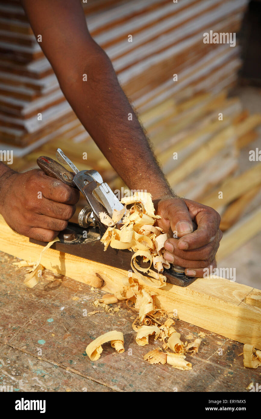 Carpenter working with plane Stock Photo