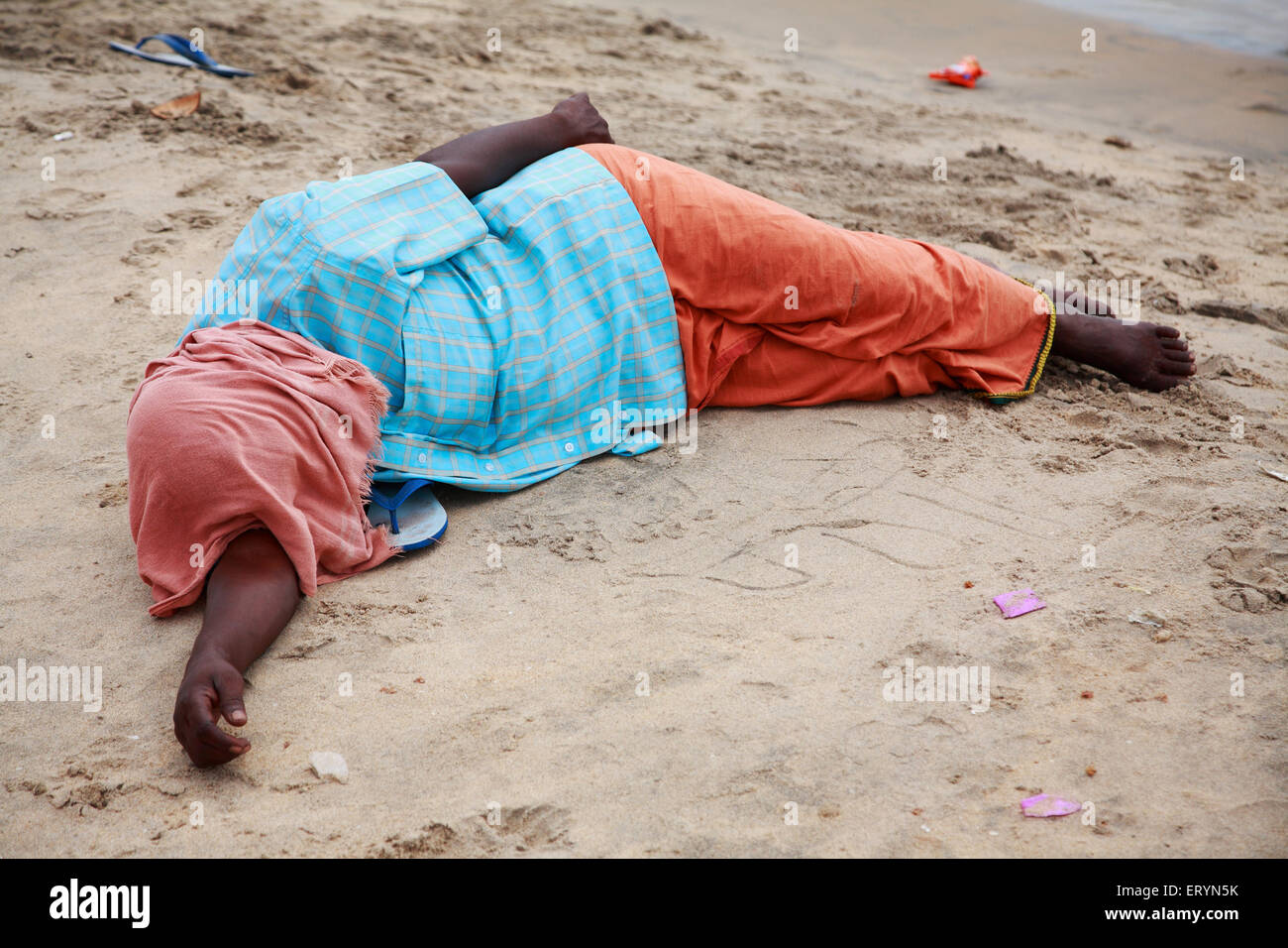 Tourist taking rest on sand ; Vailankanni  Velanganni ; Nagapattinam Nagappattinam ; Tamil Nadu ; India NO MR Stock Photo