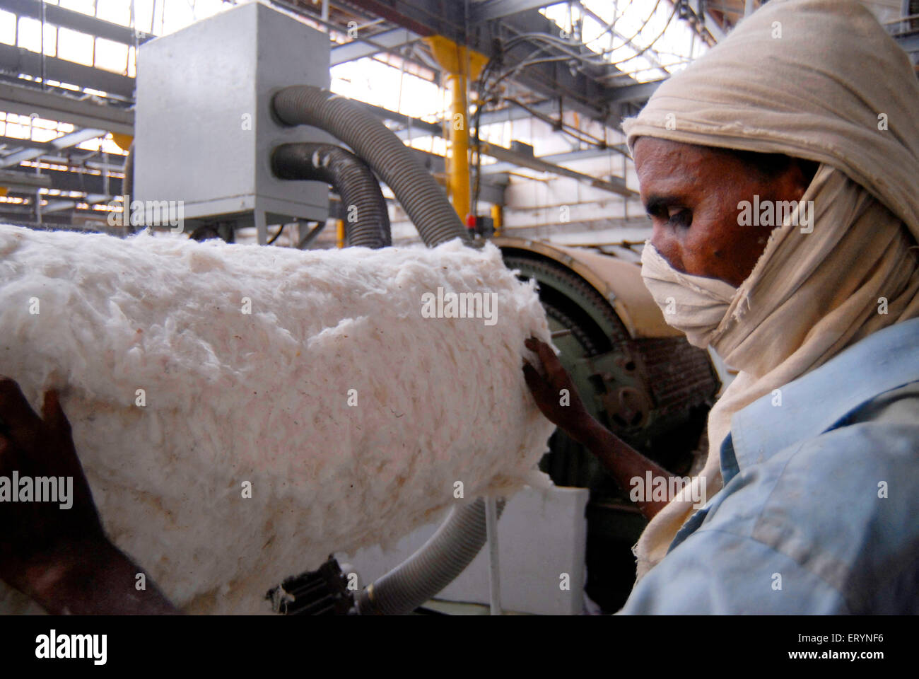 Textile mill worker covers his face as he work in a textile mill in Bombay now Mumbai ; Maharashtra ; India Stock Photo
