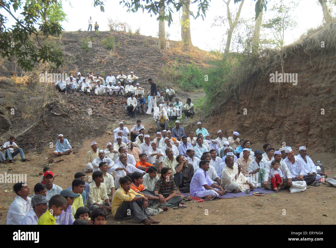 Villager people sitting and watching local fair , Dimba village ; district Pune ; Maharashtra ; India , asia Stock Photo