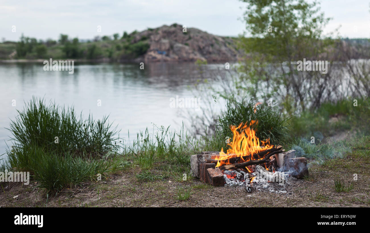 Bonfire in the spring forest. Coals of fire. Twilight in Ukraine Stock Photo